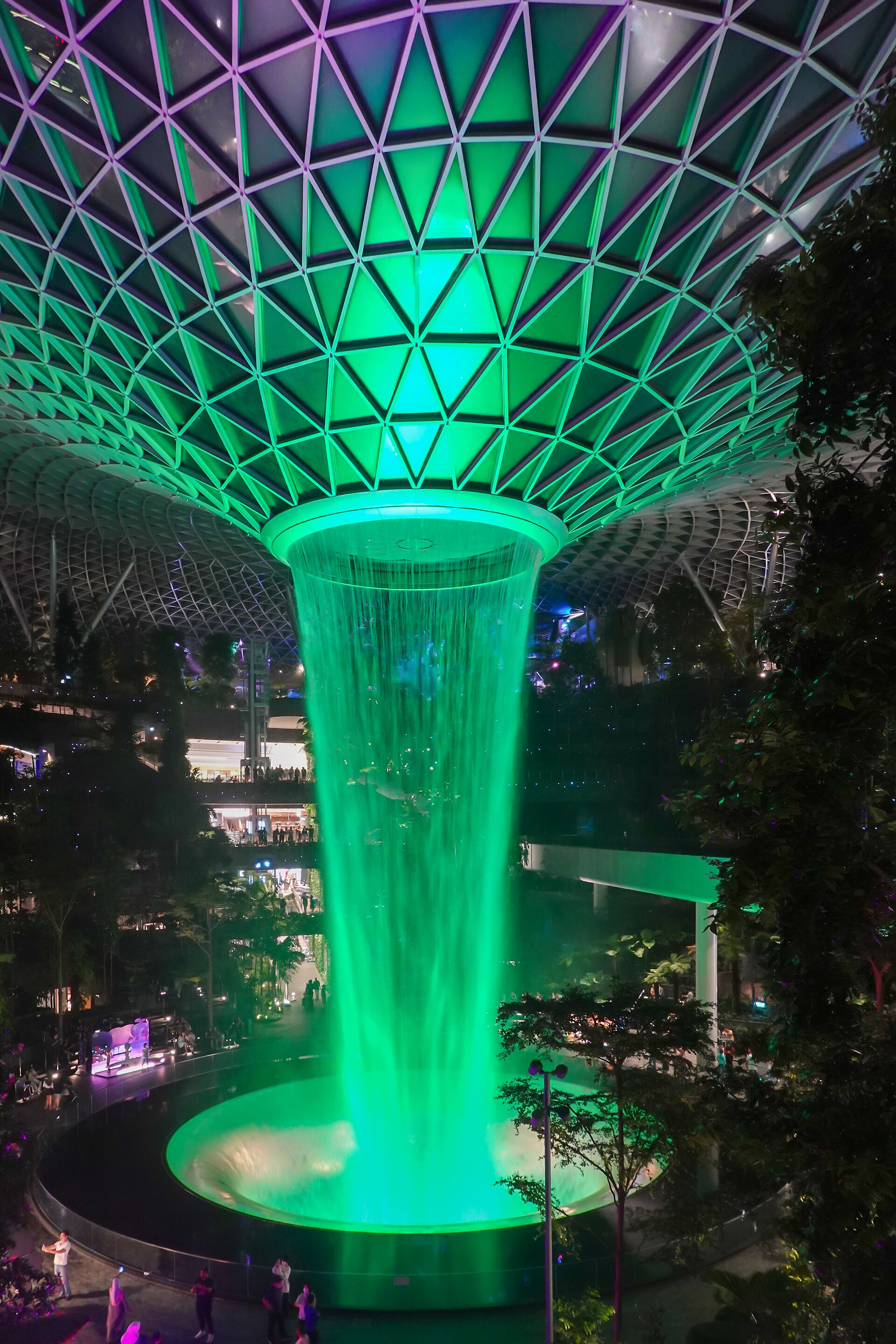 HSBC Rain Vortex glowing green inside Jewel Changi Airport